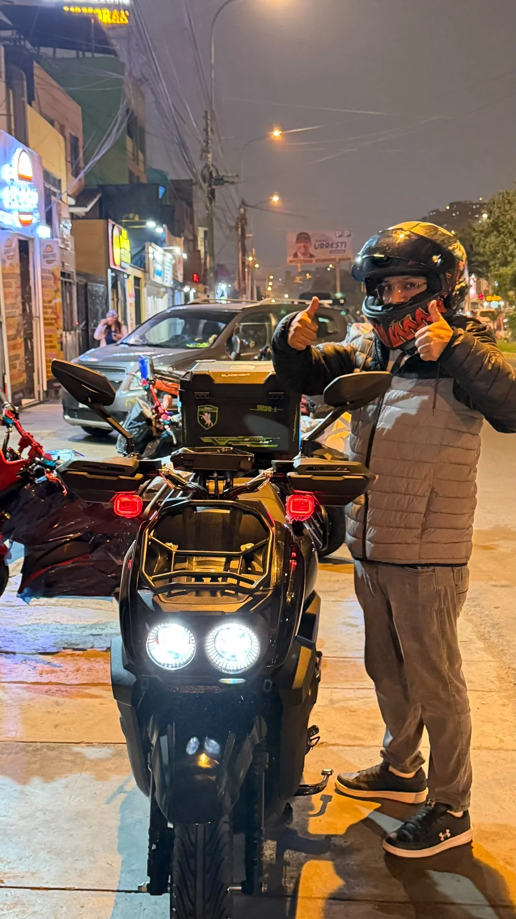 Cliente Dorcas en entrega nocturna con scooter electrico negro